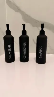 three black bottles sitting on a white counter at FREE Pool Table Cinema Room TableTennis AirHockey Glasgow City in Glasgow