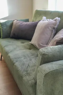a couch with pillows on it in a living room at Castlehill House in Boʼness