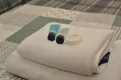 a towel with a toothbrush and a tube of tooth paste at The Hopetoun Arms Hotel in Leadhills