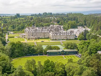an aerial view of a large mansion with trees at Spacious Gleneagles Apartment