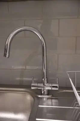 a kitchen sink with a faucet on top of it at Elegant 3BR Apt at Haymarket in Edinburgh