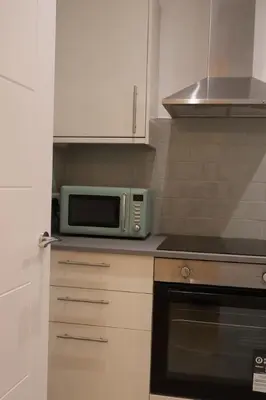 a microwave oven sitting on top of a kitchen counter at Elegant 3BR Apt at Haymarket in Edinburgh