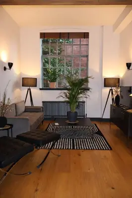 a living room with a couch and a window at Stockbridge 1BR with Parking in Edinburgh