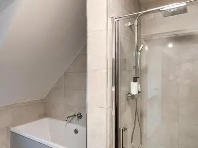 a bathroom with a shower and a bath tub at Eriska View in Port Appin