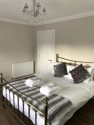 a bedroom with a bed with two pillows on it at Inglewood House and Spa in Alloa