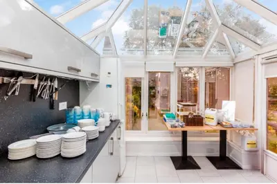 a kitchen with a glass roof with plates on a counter at West Coates Mansion in Edinburgh