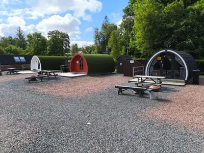 a group of tents and picnic tables in a park at Barrhill Holiday Park - Glamping in South West Scotland - Stinchar in Girvan
