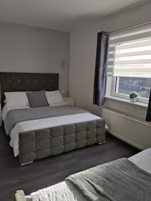 a bedroom with two beds and a window at Anchorage Accommodation in Balloch