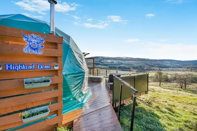 a wooden deck with a sign on a highland davis luxury house at 1 Bed in Denny oc-h33665 in Denny