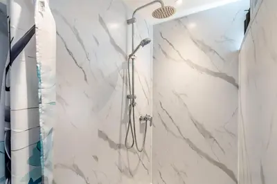 a shower in a bathroom with white marble at 1 Bed in Denny oc-h33665 in Denny