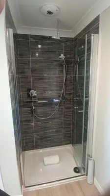 a shower with a glass door in a bathroom at Salen Pier Haven in Salen