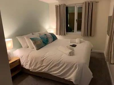 a white bed with towels on it in a bedroom at Salen Pier Haven in Salen
