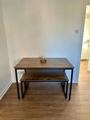 a wooden table with a box on top of it at Lochside Hub in Balloch