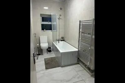 a bathroom with a tub and a toilet and a sink at 23 Ash road in Moffat
