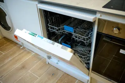 a dishwasher with a dish rack in it at The Oban Apartment in Oban