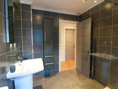 a bathroom with a sink and a shower at Cramar Cottage in Glasgow