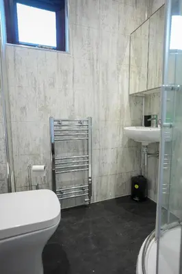 a bathroom with a toilet and a sink at Nigel House in Livingston