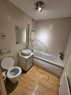 a bathroom with a toilet and a sink and a tub at Glasgow Southside Apartment in Glasgow