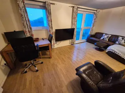 a living room with a couch and a table and a couch at Glasgow Southside Apartment in Glasgow