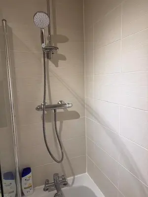 a shower in a bathroom with a bath tub at Glasgow Southside Apartment in Glasgow