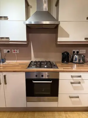 a kitchen with a stove top oven in a kitchen at Glasgow Southside Apartment in Glasgow
