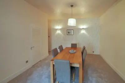 a dining room with a wooden table and chairs at Mariners Haven in Troon in Troon