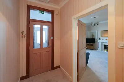 a hallway with a door and a living room at Mariners Haven in Troon in Troon