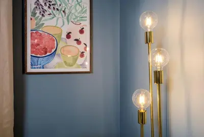 a painting of a bowl of fruit on a wall with two lights at Modern 1-Bed Retreat by Stirling Train Station in Stirling