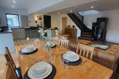 a dining room table with plates and dishes on it at 3 Bed House - Sea Views Balcony Parking Pets in Innellan