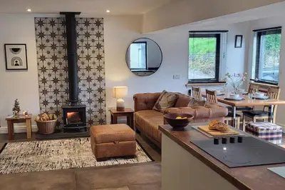 a living room with a couch and a fireplace at 3 Bed House - Sea Views Balcony Parking Pets in Innellan