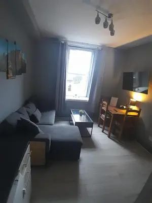 a living room with a couch and a table at Cosy Apartment by the Meadows 2 in Edinburgh