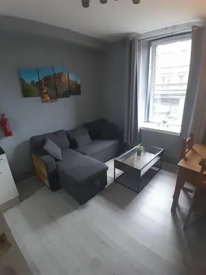 a living room with a couch and a coffee table at Cosy Apartment by the Meadows 2 in Edinburgh