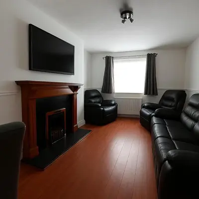 a living room with a couch and a fireplace at Carvetii - Jute House, ground floor, 2 bedroom flat in Rosyth