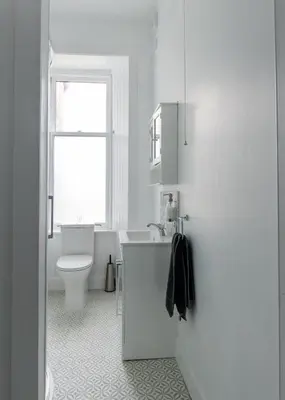 a white bathroom with a toilet and a sink at Island View in Campbeltown