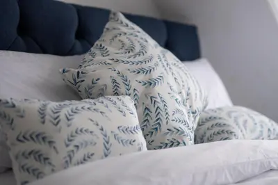 a pile of pillows sitting on a bed at Island View in Campbeltown