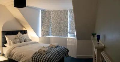 a bedroom with a bed and a window at Island View in Campbeltown