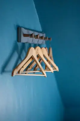 a group of wooden hangers hanging from a blue wall at Island View in Campbeltown