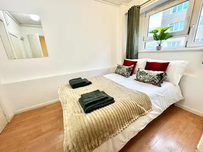 a bedroom with a bed in a room with a window at Entire 4 bedrooms Apartment Sleep 8 Central London ZONE1 in Moffat