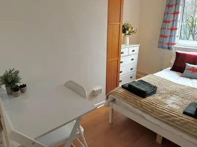 a small bedroom with a bed and a dresser at Entire 4 bedrooms Apartment Sleep 8 Central London ZONE1 in Moffat