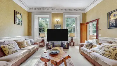 a living room with couches and a flat screen tv at Finest Retreats - Ormidale House in Feorlean