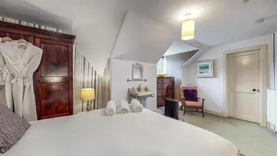 a bedroom with a large white bed in a room at Finest Retreats - Ormidale House in Feorlean