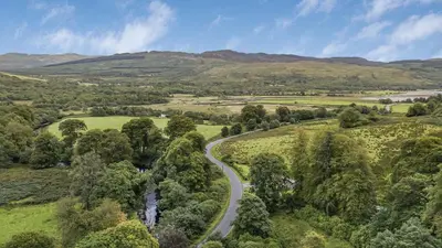 an aerial view of a road in the hills at Finest Retreats - Mill House at Ormidale House in Clachan of Glendaruel