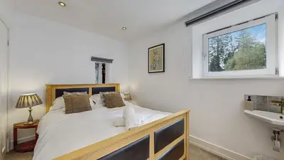 a bedroom with a bed and a window and a sink at Finest Retreats - Mill House at Ormidale House in Clachan of Glendaruel