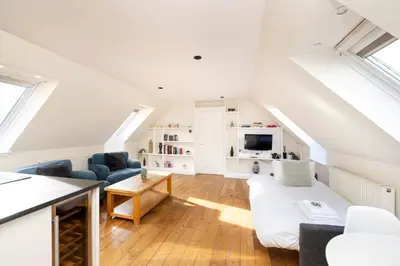 a loft conversion with a living room and a kitchen at JOIVY Lovely Flats in Edinburgh City Centre in Edinburgh