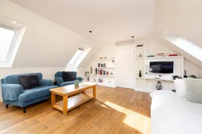 a living room with a couch and a table at JOIVY Lovely Flats in Edinburgh City Centre in Edinburgh