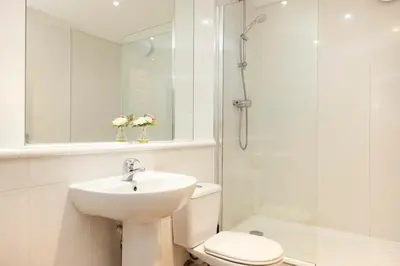 a bathroom with a sink and a toilet and a shower at JOIVY Lovely Flats in Edinburgh City Centre in Edinburgh