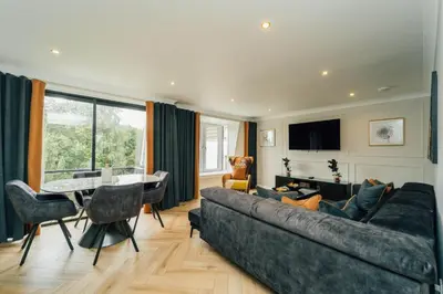 a living room with a couch and a table at Eagleside Apartments in Auchterarder