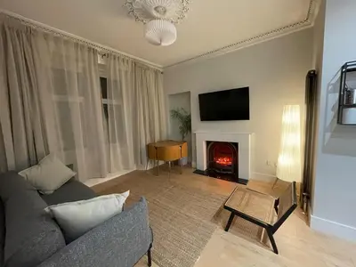 a living room with a couch and a fire place at Cosy Coastal getaway 2 bed flat in Largs in Largs