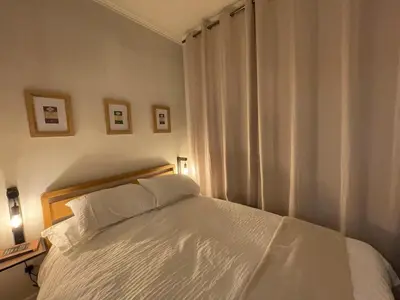 a bedroom with a white bed and a window at Cosy Coastal getaway 2 bed flat in Largs in Largs
