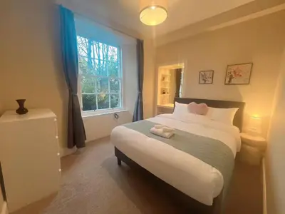 a bedroom with a large bed and a window at Adorable 2BR Apartment in Edinburgh